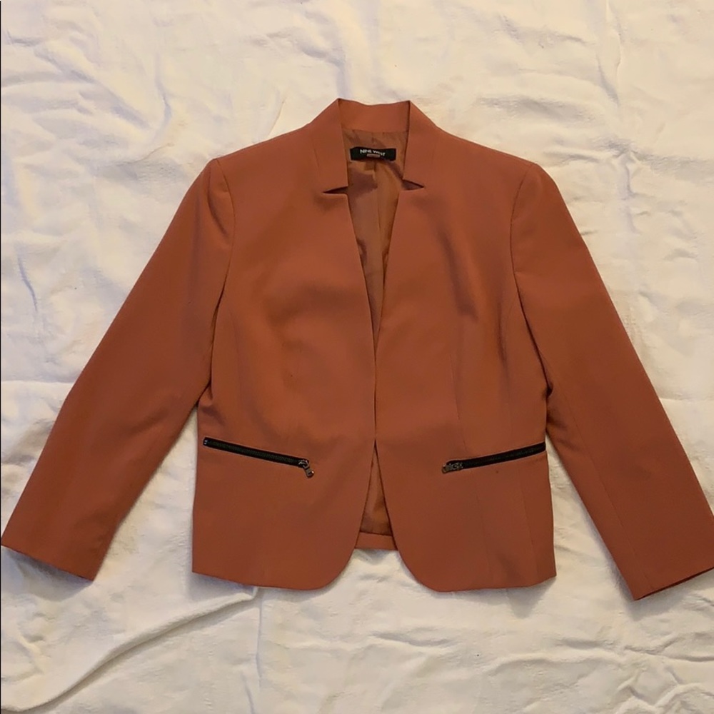 Burgundy colored suit with black zipper detailing.